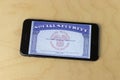 Social Security card blank on a smartphone. The Social Security Administration oversees retirement, disability benefits