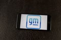 General Motors new logo on a smartphone. GM is promoting the new symbol with the goal of selling only Zero-Emission vehicles