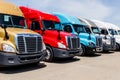 Indianapolis - Circa June 2018: Colorful Freightliner Semi Tractor Trailer Trucks Lined up. Freightliner is owned by Daimler AG IV