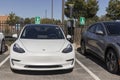 Tesla EV electric vehicle on display at a Blink EV charger. Tesla products include electric cars, battery energy storage and solar