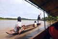 Indians overtakes tourist canoe, Rio Napo Royalty Free Stock Photo