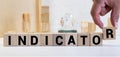 Indicate word on wooden blocks on cyan background. Financial indicator Unsecured and secured bonds or KPI concept