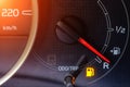 The indicator in the car on the dashboard warns of low fuel level Royalty Free Stock Photo