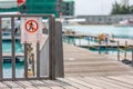 Indicator sign. No entry. Sign on the fence wooden gate with blurred airplane wings