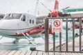 Indicator sign. No entry. Sign on the fence wooden gate with blurred airplane wings rotor plane