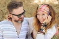 Indie style smiling couple, woman embracing man, hipster outfit, boho chic