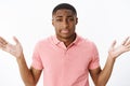 Indifferent boyfriend cannot get clue why girlfriend angry. Clueless and confused young african american man shrugging