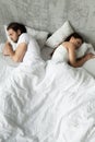 Indifferent couple sleep separately avoiding intimacy in bed