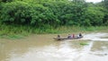 Indigenes on a canoe boat on the Amazon River Royalty Free Stock Photo