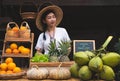 Asian women with a natural assortment of fruits welcome tourists at the farm stay. Homestay in Thailand