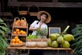 Asian women raise their hands pay respect to greet tourists with a natural assortment of fruits to welcome tourists to