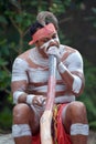 Indigenous Australian Man playing Aboriginal Music on Didgeridoo Instrument Royalty Free Stock Photo