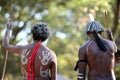 Indigenous Australian men holding traditional weapons during a ceremonial dance in Cape York Queensland Australia