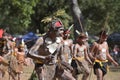 Indigenous Australian men holding traditional weapons during a ceremonial dance in Cape York Queensland Australia