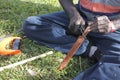 Indigenous Australians aboriginal craftman making a a wooden Australian Aboriginal spear