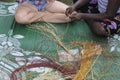 Indigenous Australians aboriginal woman teaching a tourist Aboriginal basket weaving Royalty Free Stock Photo