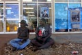 Indigenous Australians men sitting outside ANZ bank Royalty Free Stock Photo