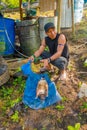 Indigenous Ecuadorian shaman guy butchering an armadillo for lunch