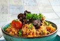 Indigenous Ghanaian, African-Caribian food Jollof Rice with tomato sause, regional spices, chicken meat and offal