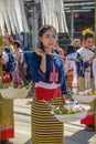 Indigenous girl holding counterpoise with 2 enameled basin of food in parade Royalty Free Stock Photo