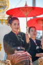 Indigenous girl holding red paper umbrella