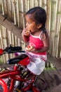 Indigenous Girl Eating A Piece Of Bread With Jam