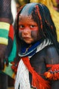 Indigenous little girl wearing tribal paint and adornments