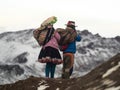 Indigenous local in traditional colourful andean clothes at Vinicunca Rainbow Mountain, Cuzco Peru Andes in snowy winter