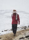 Indigenous local in traditional colourful andean clothes at Vinicunca Rainbow Mountain, Cuzco Peru Andes in snowy winter