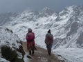 Indigenous local in traditional colourful andean clothes at Vinicunca Rainbow Mountain, Cuzco Peru Andes in snowy winter