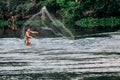 Indigenous man net fishing at Xingu River