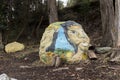 Indigenous man and woman painted on a rock on a Lake Tota island