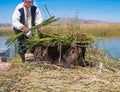 Indigenous man working on the traditional village of the floating Uros Islands