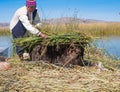 Indigenous man working on the traditional village of the floating Uros Islands