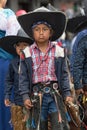 Indigenous quechua boy wearing chaps and sombrero