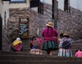 Indigenous quechua women in traditional colorful handwoven textile clothing dress costume walking in Cusco Peru Royalty Free Stock Photo