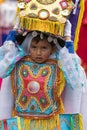 Indigenous quechua young boy wearing a headdress