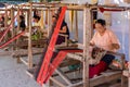 Indigenous senior women are weaving fabric