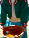 Indigenous woman showing the caught fish in Islas flotantes de los Uros on the lake Titicaca, Peru