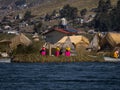 Indigenous women in colorful traditional dresses on Uros Floating reed Islands on Lake Titicaca Puno Peru South America