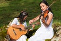 Indigenous women with instruments singing in nature