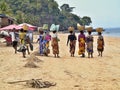 Indigenous women in traditional clothes hampers with their heads, Nosy Be, Madagascar