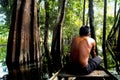 Indigenous man riding a canoe into the wet forest in Brazil Royalty Free Stock Photo
