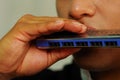 Indigenous young man playing the harmonica Royalty Free Stock Photo