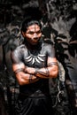 Indigenous young warrior wearing body paint and adornments