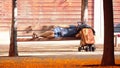 Indigent man sleeping on a bench in a park. Homeless and social problem concept. Empty copy space Royalty Free Stock Photo