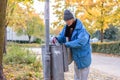 Indigent senior woman scrounging through a bin Royalty Free Stock Photo