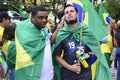 Indignant boys with the Brazilian flag on their backs at the demonstration