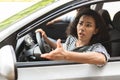 Indignant brunette lady driver fighting on the road