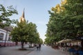 Main pedestrian street of Indjija, Ulica Vojvode Stepe, with a chuchr, trees and cafes visible. Royalty Free Stock Photo